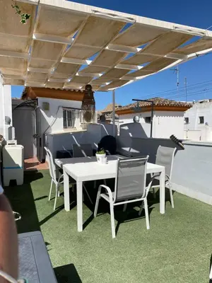 a white table and chairs under awning on a patio at LAS 7 ESQUINAS in El Puerto de Santa María