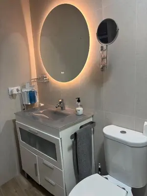 a bathroom with a sink and a toilet and a mirror at LAS 7 ESQUINAS in El Puerto de Santa María