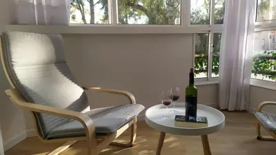 a table with a bottle of wine and a glass at Casa Julia in Sanlúcar de Barrameda