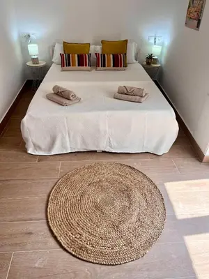a bedroom with a large bed with two pillows on it at GATU PREMIUM Villa Flamenca , Preferente mayores de 25 años y familias in Cádiz