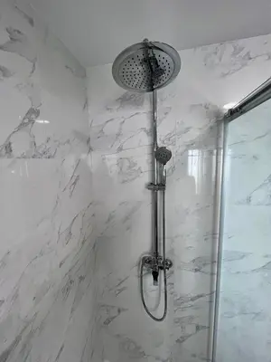 a shower in a bathroom with white marble at GATU PREMIUM Villa Flamenca , Preferente mayores de 25 años y familias in Cádiz