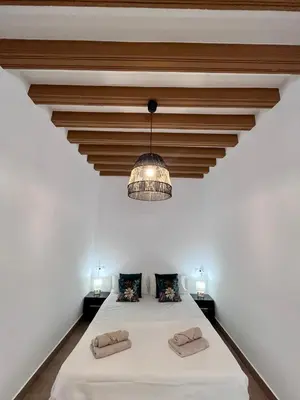 a bedroom with a large white bed with a ceiling at GATU PREMIUM Villa Flamenca , Preferente mayores de 25 años y familias in Cádiz