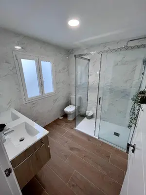 a bathroom with a shower and a toilet and a sink at GATU PREMIUM Villa Flamenca , Preferente mayores de 25 años y familias in Cádiz