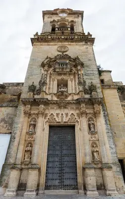 a tall tower with a clock on top of it at Casa PauMar, tu casa en Arcos de la Frontera in Arcos de la Frontera