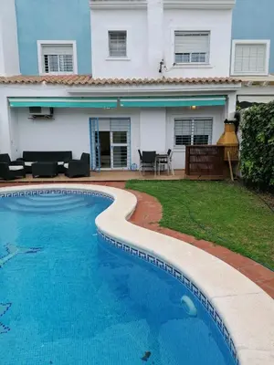 a swimming pool in front of a house at Casa con piscina privada in El Puerto de Santa María