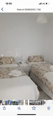 two beds sitting next to each other in a bedroom at Casa con piscina privada in El Puerto de Santa María