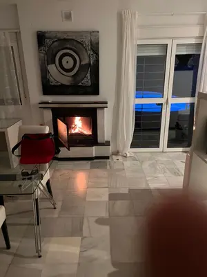 a living room with a fire in a fireplace at Casa con piscina privada in El Puerto de Santa María