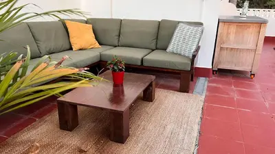 a living room with a couch and a coffee table at Arriba stijlvol appartement met zwembad en tuin in Conil de la Frontera