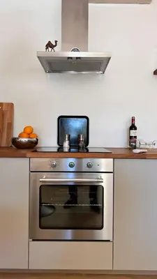 a kitchen with a stainless steel stove top oven at Arriba stijlvol appartement met zwembad en tuin in Conil de la Frontera