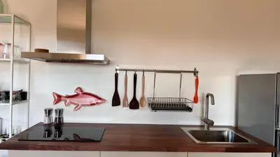 a kitchen with a sink and a counter with utensils at Arriba stijlvol appartement met zwembad en tuin in Conil de la Frontera