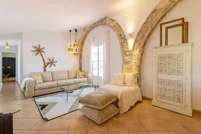 a living room with a couch and a table at Ático La Casa Rosa - Parking opcional in Jerez de la Frontera