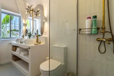 a bathroom with a toilet and a sink and a mirror at Ático La Casa Rosa - Parking opcional in Jerez de la Frontera