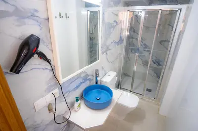 a bathroom with a shower and a toilet with a phone at MARÍTIMO28 in Cádiz