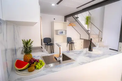 a kitchen with a sink and a plate of fruit at MARÍTIMO28 in Cádiz