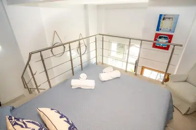 a room with a bed with two towels on it at MARÍTIMO28 in Cádiz