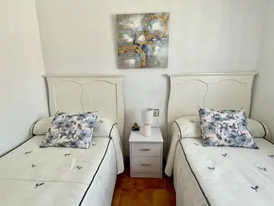 a bedroom with a bed with two pillows on it at Chalet Er SentI in Novo Sancti Petri