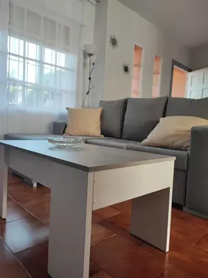 a bedroom with two beds and a window at Chalet Er SentI in Novo Sancti Petri