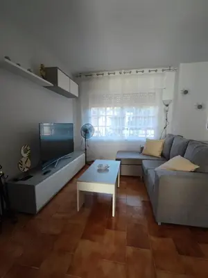 a living room with a couch and a table at Chalet Er SentI in Novo Sancti Petri