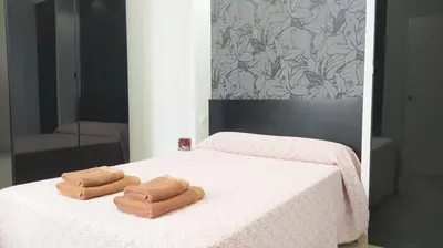 two towels on a bed in front of a mirror at Sherryflat Arroyo in Jerez de la Frontera