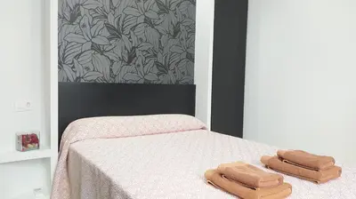 a bedroom with a bed with two towels on it at Sherryflat Arroyo in Jerez de la Frontera
