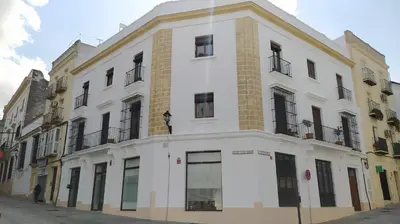 a white building on a city street at Sherryflat Arroyo in Jerez de la Frontera