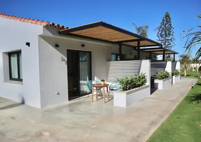 a house with a patio with a table and chairs at Alojamiento rural FINCA AZUCENA SUITE only adults in Conil de la Frontera
