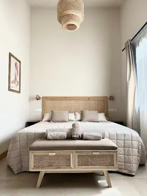 a bedroom with a large bed in a white room at Alojamiento rural FINCA AZUCENA SUITE only adults in Conil de la Frontera