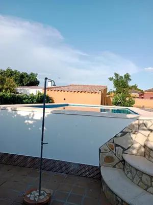 a swimming pool in front of a house at Chalet Villa Terry in Chiclana de la Frontera