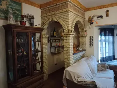 a room with a brick archway and a bed in it at Chalet Villa Terry in Chiclana de la Frontera