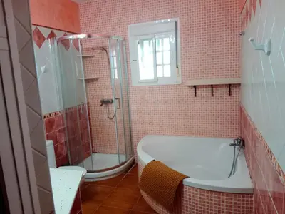 a bathroom with a shower and a tub and a sink at Chalet Villa Terry in Chiclana de la Frontera