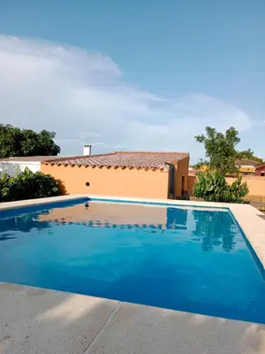 a swimming pool in front of a house at Chalet Villa Terry in Chiclana de la Frontera