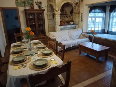 a living room with a table and a couch at Chalet Villa Terry in Chiclana de la Frontera