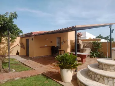 a patio with a glass extension on a house at Chalet Villa Terry in Chiclana de la Frontera