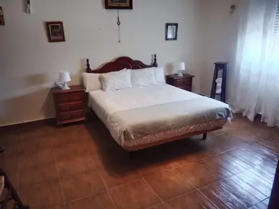 a bedroom with a large bed and two night stands at Chalet Villa Terry in Chiclana de la Frontera