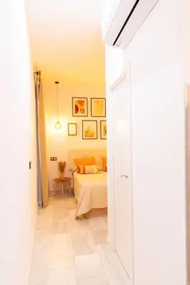 a bedroom with a bed and a room with a table at La Gloria in Cádiz
