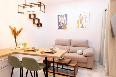 a living room with a table and a couch at La Gloria in Cádiz