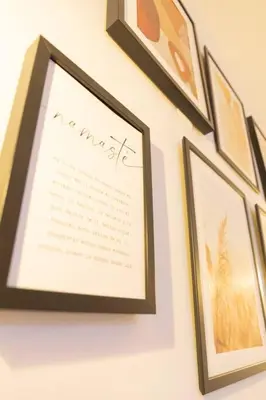 a group of framed pictures hanging on a wall at La Gloria in Cádiz