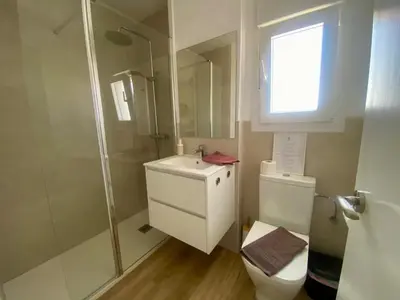 a bathroom with a toilet and a shower and a sink at APARTAMENTO VISTAS AL MAR - Valdelagrana Playa in El Puerto de Santa María