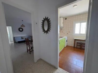 a kitchen and dining room with a table and a mirror at APARTAMENTO VISTAS AL MAR - Valdelagrana Playa in El Puerto de Santa María
