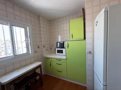 a kitchen with a green refrigerator and a microwave at APARTAMENTO VISTAS AL MAR - Valdelagrana Playa in El Puerto de Santa María
