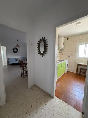 a kitchen and living room with a mirror on the wall at APARTAMENTO VISTAS AL MAR - Valdelagrana Playa in El Puerto de Santa María