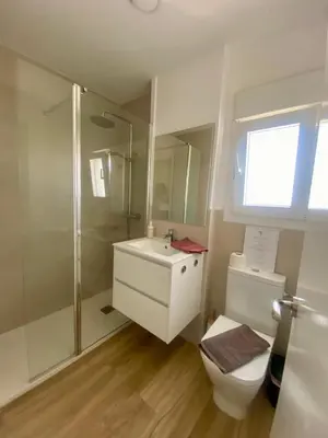 a bathroom with a toilet and a shower and a sink at APARTAMENTO VISTAS AL MAR - Valdelagrana Playa in El Puerto de Santa María