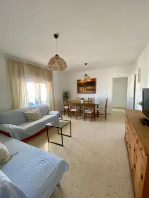 a living room with a couch and a table at APARTAMENTO VISTAS AL MAR - Valdelagrana Playa in El Puerto de Santa María