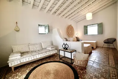 a living room with a couch and a table at Alojamiento rural CASAPIÑA in Conil de la Frontera