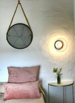 a room with a bed and a table with a mirror at Alojamiento rural CASAPIÑA in Conil de la Frontera