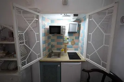 a small kitchen with a sink and a microwave at La Boveda de Hércules in Medina Sidonia