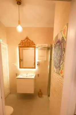 a bathroom with a sink and a mirror at La Boveda de Hércules in Medina Sidonia