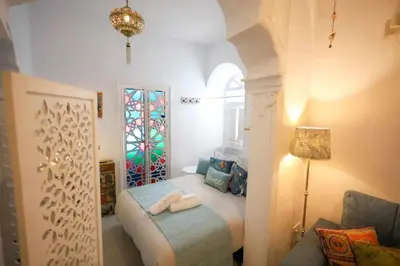 a bedroom with a bed with two towels on it at La Boveda de Hércules in Medina Sidonia