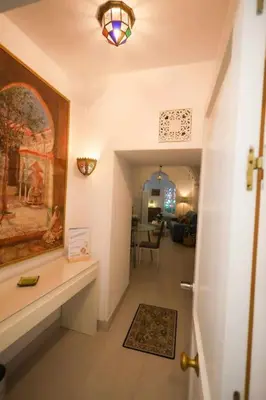 a hallway of a house with a painting on the wall at La Boveda de Hércules in Medina Sidonia