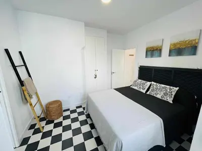 a bedroom with a bed and a checkered floor at Casa Las 4 Esquinas by Casas con Encanto in Medina Sidonia